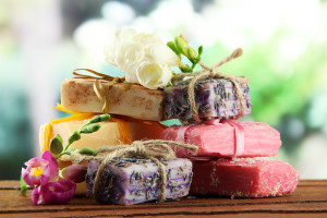 Natural handmade soap, on wooden table, on green background